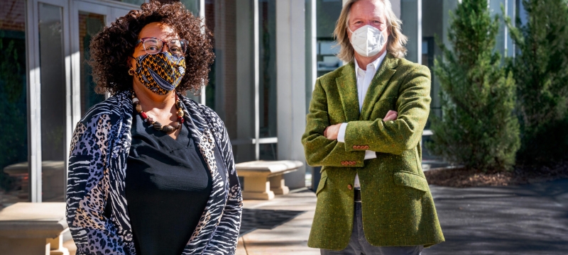 photo of two people wearing masks, outside