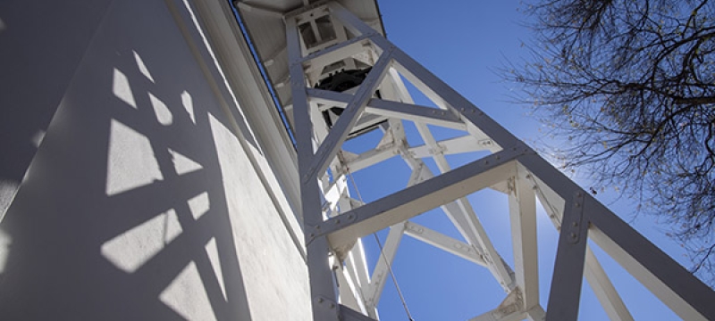 photo of bell tower and blue sky from below