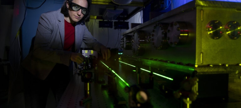 photo of woman in lab with laser