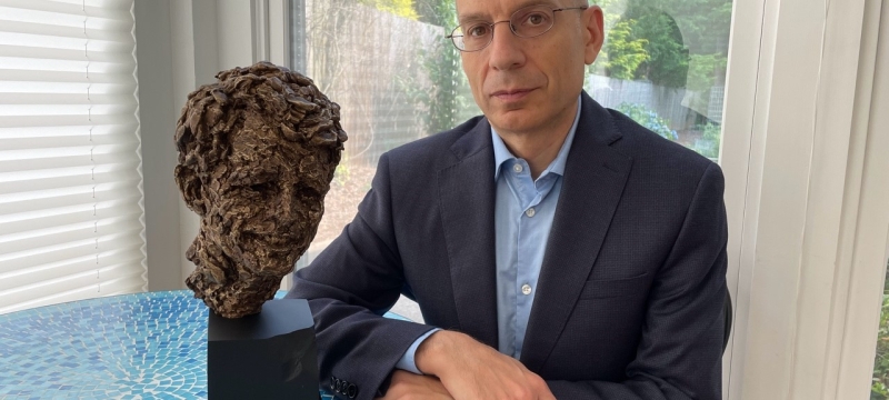 photo of man with bust sculpture