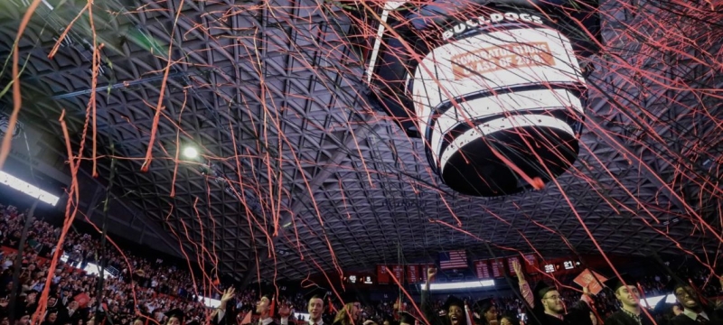 photo of indoor commencement ceremony celebration, with streamers