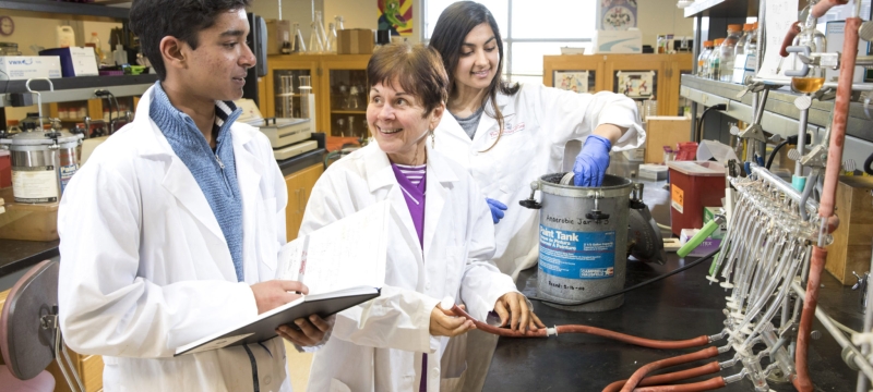 photo of three people in white lab coats, laboratory