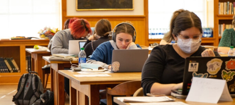 photo of students with computers in library 