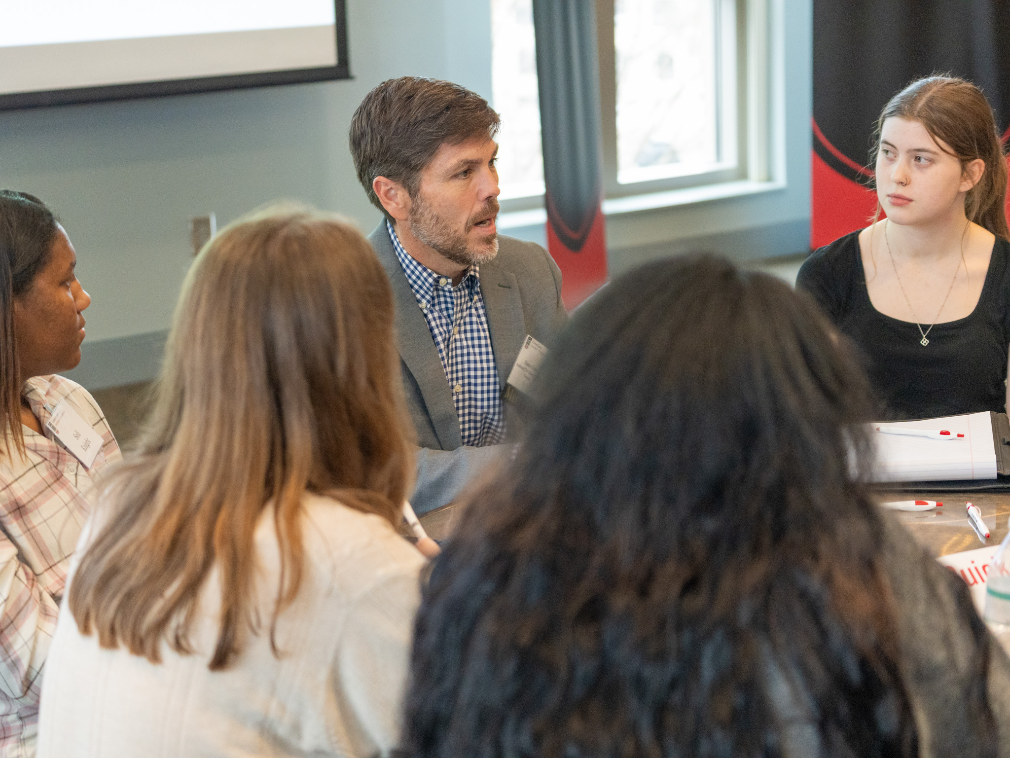 Faculty speaking around a table