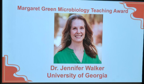 Photo of screen with photo of woman.