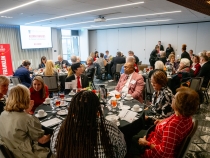 wide photo of people at tables