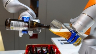 photo of two robot arms pouring beer into a glass