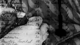 video still of hans sewing in black and white, with text