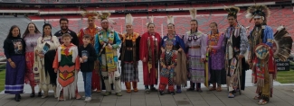 photo of Native Americans in indigenous dress at stadium