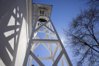 photo of bell tower and blue sky from below 