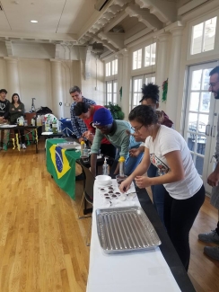 photo of students with table, flag and food