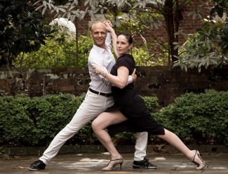 photo of two people in a dance pose, garden backdrop