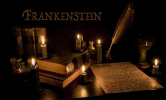graphic with Frankenstein word, quill pen and paper, candles