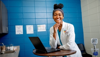 photo of woman with laptop in exam room