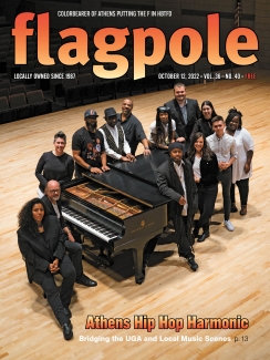 cover photo for magazine with 13 people standing around a grand piano on a concert stage