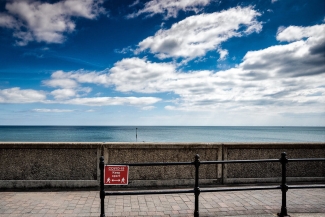 photo of open water, wall and red sign