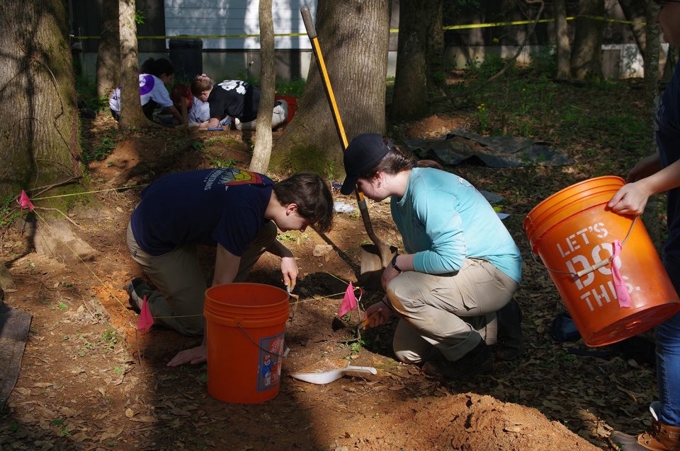 Students Reyd Mahan and Micki Cox excavate down to a burnt, compact walking surface at the ruins of the Georgia Brick Company factory located in Sandy Creek Nature Center.