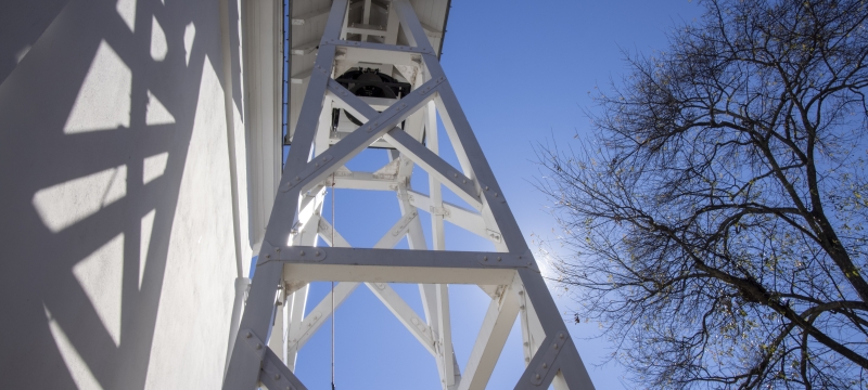 photo of bell tower and blue sky from below 