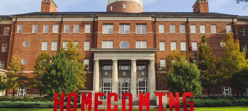 photo of building with large red letters spelling homecoming