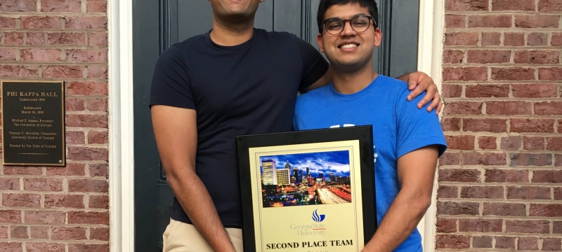 Pictured: Advait (left) and Swapnil with their 2nd place trophy.