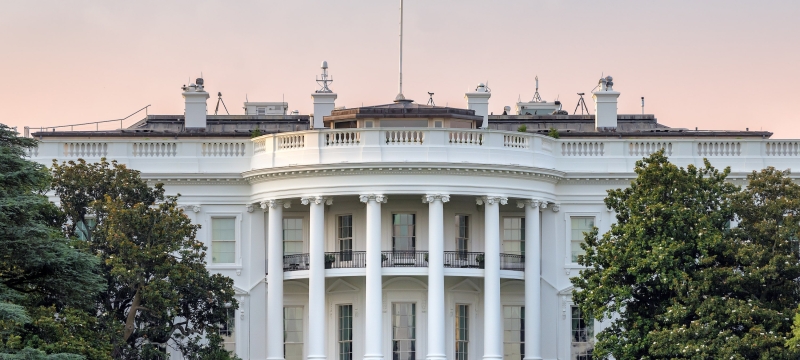 photo of U.S. White House, with flag, day
