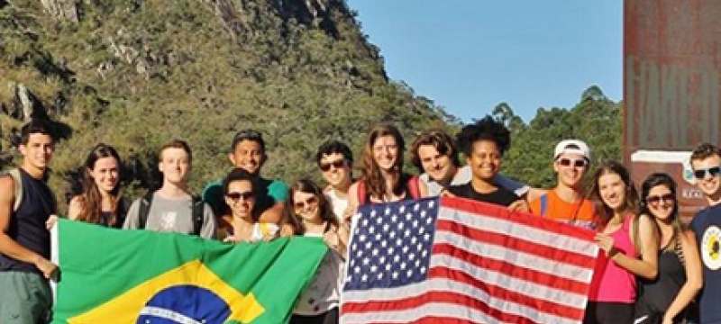 photo of students holding Brazilian and American flags