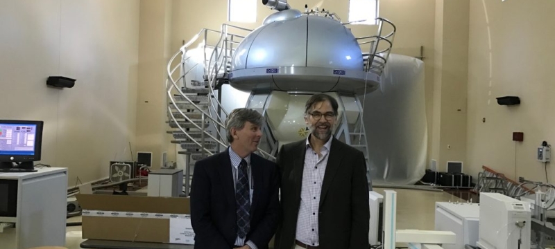 photo of men with NMR machine in background 