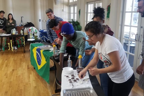 photo of students with table, flag and food