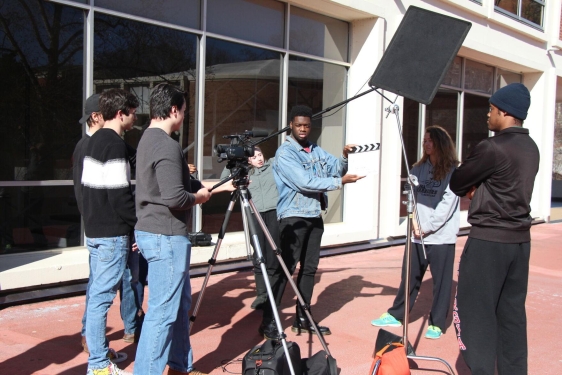 photo of film shoot with camera, people, clapper board, outdoors day