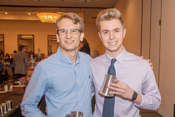 Photo of two men holding silver steins