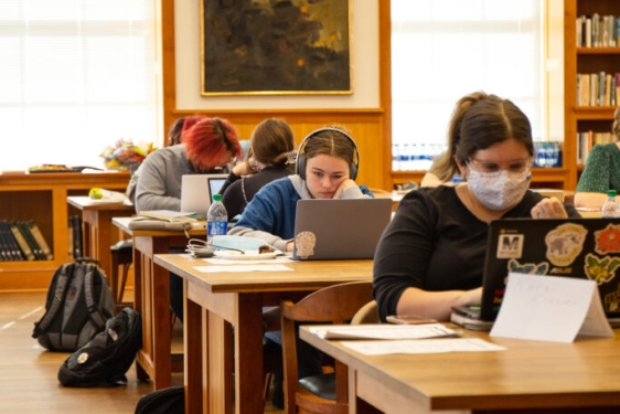 photo of students with computers in library 