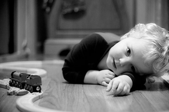child in b/w with trains 