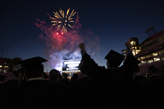 photo with fireworks and silhouette of graduate
