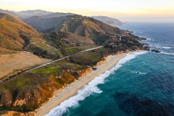 aerial photo of the California coast, with mountains and ocean