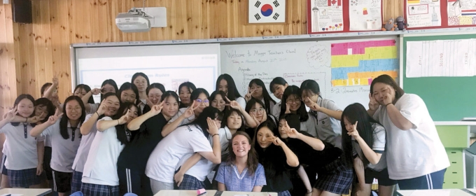 photo of woman with students in classroom