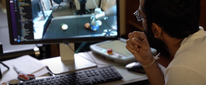 video still image of man looking at computer screen