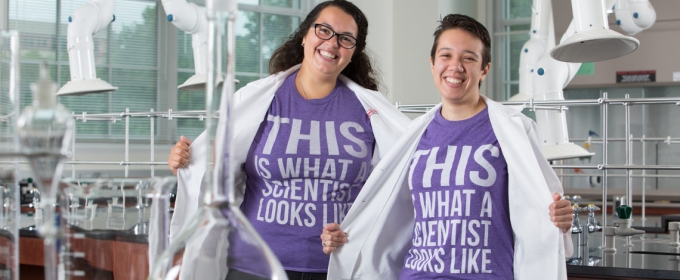 photo of women in lab coats and t-shirt in a lab