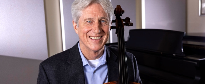 photo of man with cello, piano in background