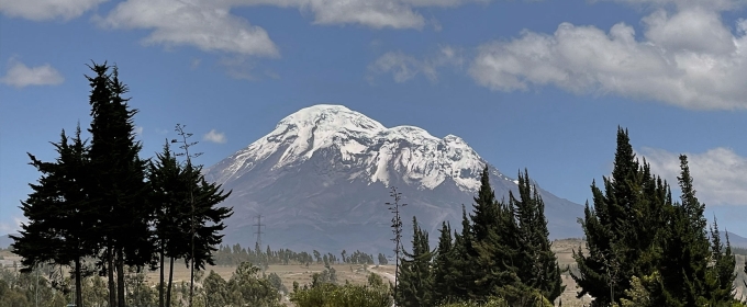 photo of snow-covered mountain, day, with trees in foreground
