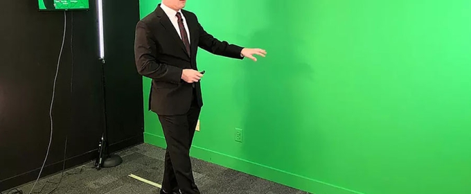 photo of man in suit with green wall